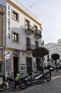 a group of motorcycles parked in front of a building at Apartamentos Trujillo in Tarifa