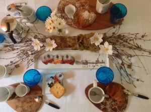 a table with plates of food and flowers on it at Casa Martina in Pescara