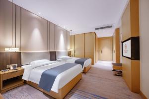 Chengdu Yunhao High-altitude Hotel客房内的一张或多张床位