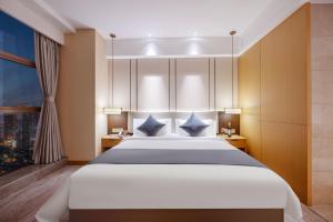 Chengdu Yunhao High-altitude Hotel客房内的一张或多张床位