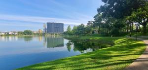 a river in a park with a grassy bank at MCity Jalan Ampang in Kuala Lumpur