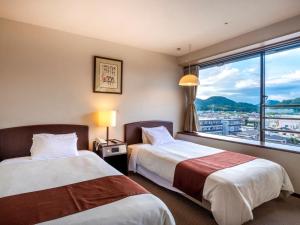Postel nebo postele na pokoji v ubytování Hotel Sunvalley Fujimi