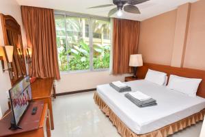 a bedroom with a bed and a large window at Piman Garden Boutique Hotel in Khon Kaen
