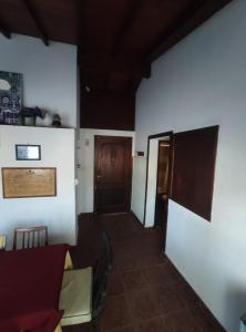a room with white walls and a table and chairs at Casa Gesell in Villa Gesell
