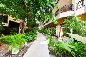 a courtyard of a building with trees and plants at Piman Garden Boutique Hotel in Khon Kaen