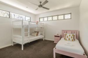 a bedroom with two bunk beds and a ceiling fan at Peppermint Sands in Dunsborough +20 photos