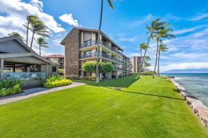 an exterior view of a house with a lawn at Papakea K103 · PK K103 Ocean views Condo | Lanai + AC + Pool in Kaanapali