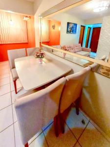 a kitchen with a table and chairs in a room at Apê Fantástico com Piscina I Wi-Fi e A/C in Imperatriz +24 photos