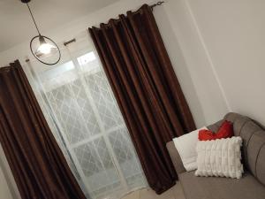 a living room with a couch and a window at Millan home stay Nyali in Mombasa