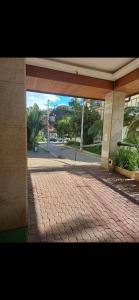 a brick walkway in front of a building at Granja Brasil Flat Itaipava in Araras Petropolis