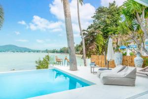 een zwembad met uitzicht op het water bij Beachfront Secret Tides Villa Luna in Koh Samui 