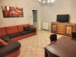 a living room with a couch and a flat screen tv at Villa Marina in Marotta