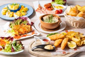 a table topped with plates of food and appetizers at Hotel JAL City Haneda Tokyo in Tokyo