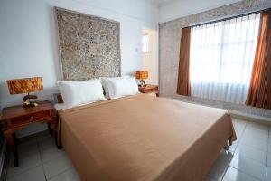 Postel nebo postele na pokoji v ubytování Ganesh Beach Hotel