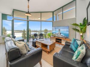 a living room with a couch and a table at Waterview Resort in Caloundra