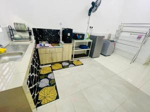 a kitchen with a sink and a counter top at D Alamanda Islam Homestay in Kuala Kangsar +3 photos