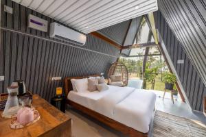 a bedroom with a large bed and a table at The Rose Goa Beach Resort in Agonda +106 photos