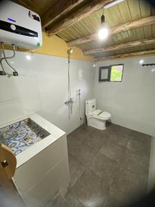 a bathroom with a toilet and a sink at Lullaby Ha Giang Homestay in Loung Co