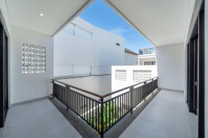 an open balcony with white walls and a large window at Rumah Stabia- 2BR in Canngu with Ping Pong Table and Pool in Canggu