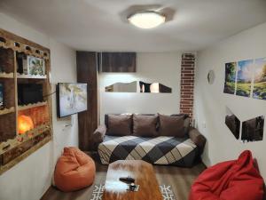a living room with a couch and a table at Къща за гости ФЪН ШУЙ 88 in Dobrinishte
