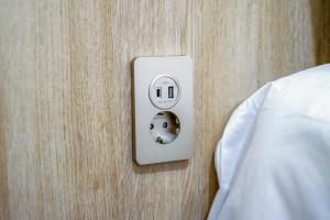 a lightswitch on a wall next to a bed at Manso Hostel in DDP in Seoul