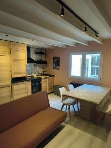 a kitchen with a table and a table and chairs at WHITE House in Burgos