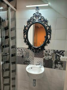 a bathroom with a sink and a mirror on the wall at WHITE House in Burgos