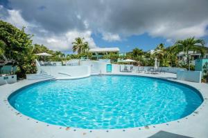 a large pool with blue water in a resort at Beautiful Ocean Views Amazing Sunsets three pool! in Nazareth