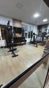 a gym with several treadmills and machines in a room at Apartamento Térreo Climatizado na Avenida Artêmia Pires Freitas in Feira de Santana