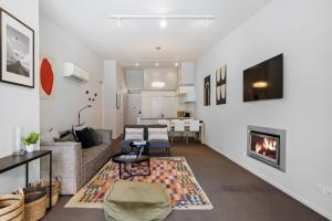 a living room with a couch and a fireplace at Stylish Haven Luxury Interiors in Prime Location in Queenstown