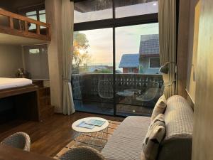 a living room with a couch and a balcony at A-Lofts Sea Studio 2 Central & Stylish in Dalumpinas Oeste +25 photos
