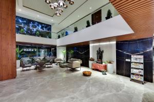 a lobby of a hotel with chairs and tables at Manasa Inn, Tirupati in Tirupati