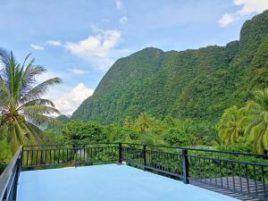 a view from the balcony of a resort with mountains at Phangnga Save House - เซฟเฮาส์พังงา in Phangnga