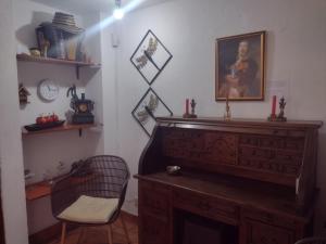 a room with a wooden dresser and a chair in it at Casa Marqués del Pedregal in Cartagena de Indias