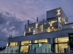 a large white building with many windows at night at Yeosu Blau Pool Villa in Yeosu