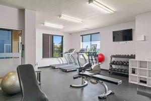a gym with several treadmills and exercise bikes at Private 2Bdrm Apartment Convenient to All in Greeley
