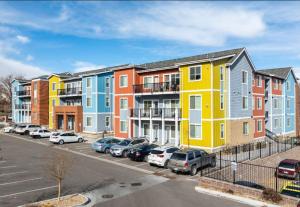 a row of houses with cars parked in a parking lot at Private 2Bdrm Apartment Convenient to All in Greeley