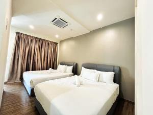 two beds in a hotel room with a window at Setapak Central Studio Suites by Manhattan Group in Kuala Lumpur +26 photos