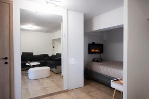 a living room with a bed and a couch at To Bee or not to Bee! in Volos