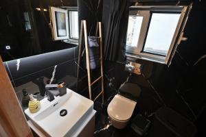 a bathroom with a white sink and a toilet at To Bee or not to Bee! in Volos