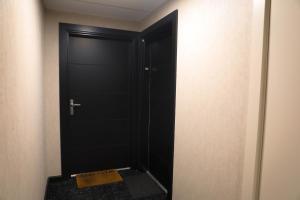 a black door with a sign in front of it at Havre de paix près de Toulouse Parking inclus in Quint-Fonsegrives