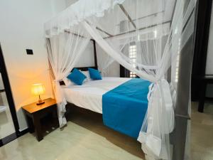 Letto o letti in una camera di JO Residence - Tangalle