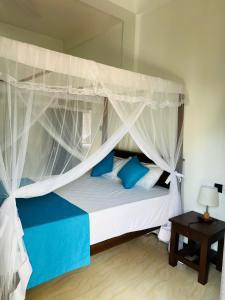 Letto o letti in una camera di JO Residence - Tangalle