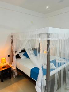 Letto o letti in una camera di JO Residence - Tangalle