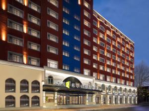 a large building with a store in front of it at Home2 Suite by Hilton Harbin Central Street in Harbin