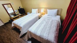 Ένα ή περισσότερα κρεβάτια σε δωμάτιο στο Kyungha Spa Hotel