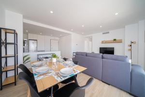 a dining room and living room with a table and chairs at Valerie in Orihuela