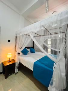 Letto o letti in una camera di JO Residence - Tangalle
