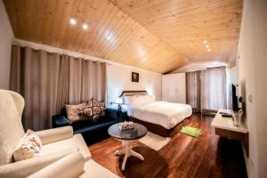 a hotel room with a bed and a couch at Holiday in Homestay in Shimla