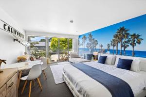 a bedroom with a large bed with a view of the ocean at Bay View Motel Number Four in Lorne